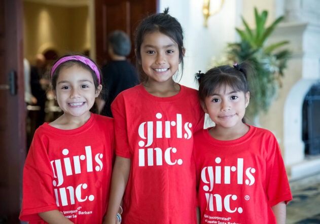 3 young smiling girls posting for a photo