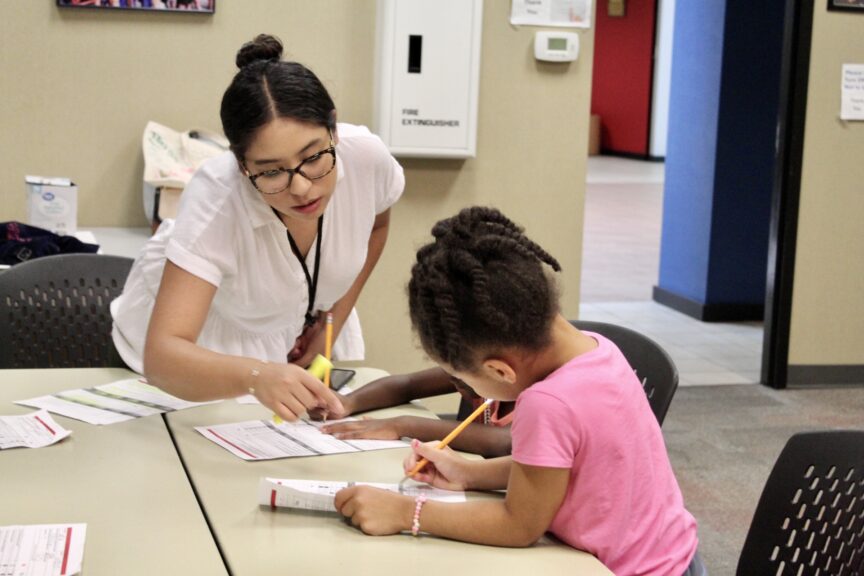 Girl at computer with mentor